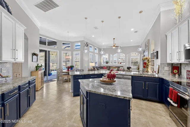 a kitchen view with stainless steel appliances lots of counter space dining table and chairs