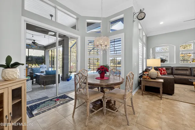a view of a dining room with furniture and chandelier