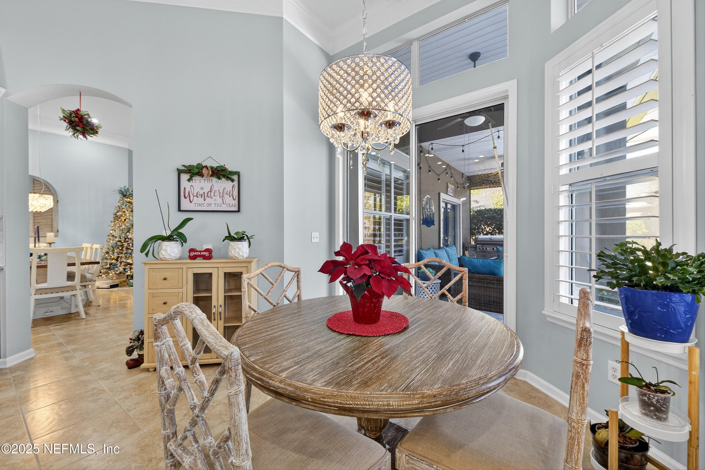 1104 Westfield Way St. Augustine, FL 32095 - Photo 24 of 53 a view of a dining room with furniture and chandelier
