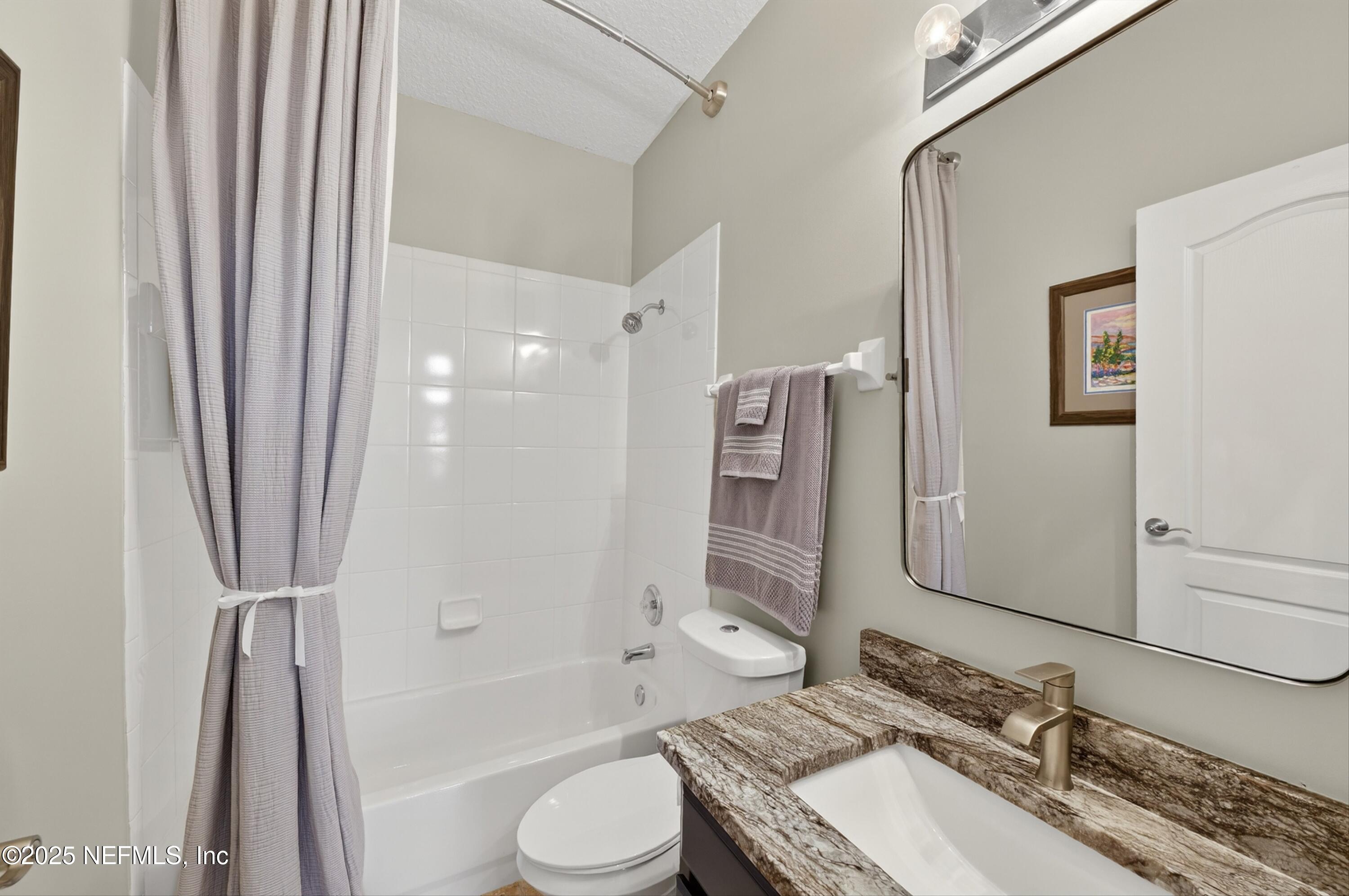 1104 Westfield Way St. Augustine, FL 32095 - Photo 33 of 53 a bathroom with a granite countertop sink toilet and shower