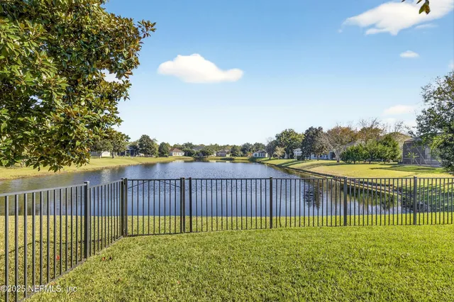 an aerial view of a houses with a lake view