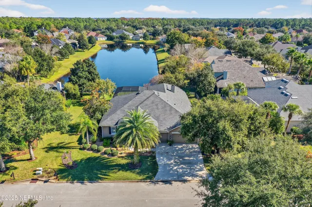 an aerial view of a houses with a lake view