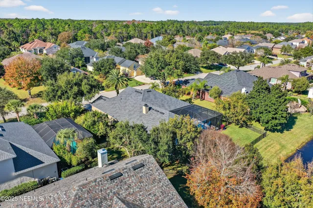 an aerial view of a houses with a swimming pool