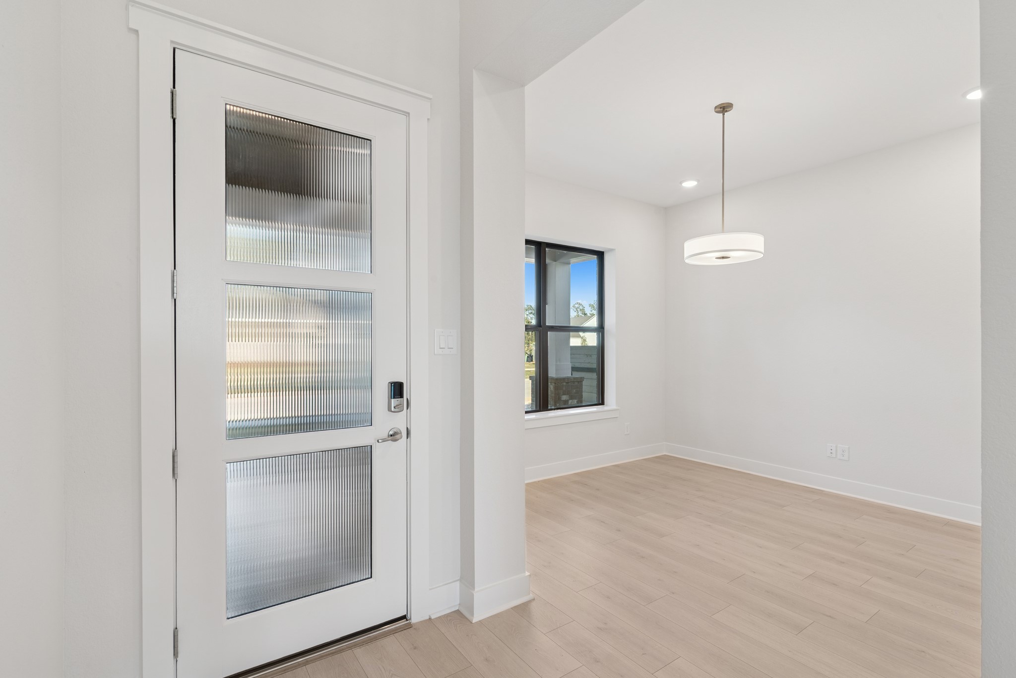 16146 Rita Road Conroe, TX 77302 - Photo 13 of 49 a view of an empty room with a window and wooden floor