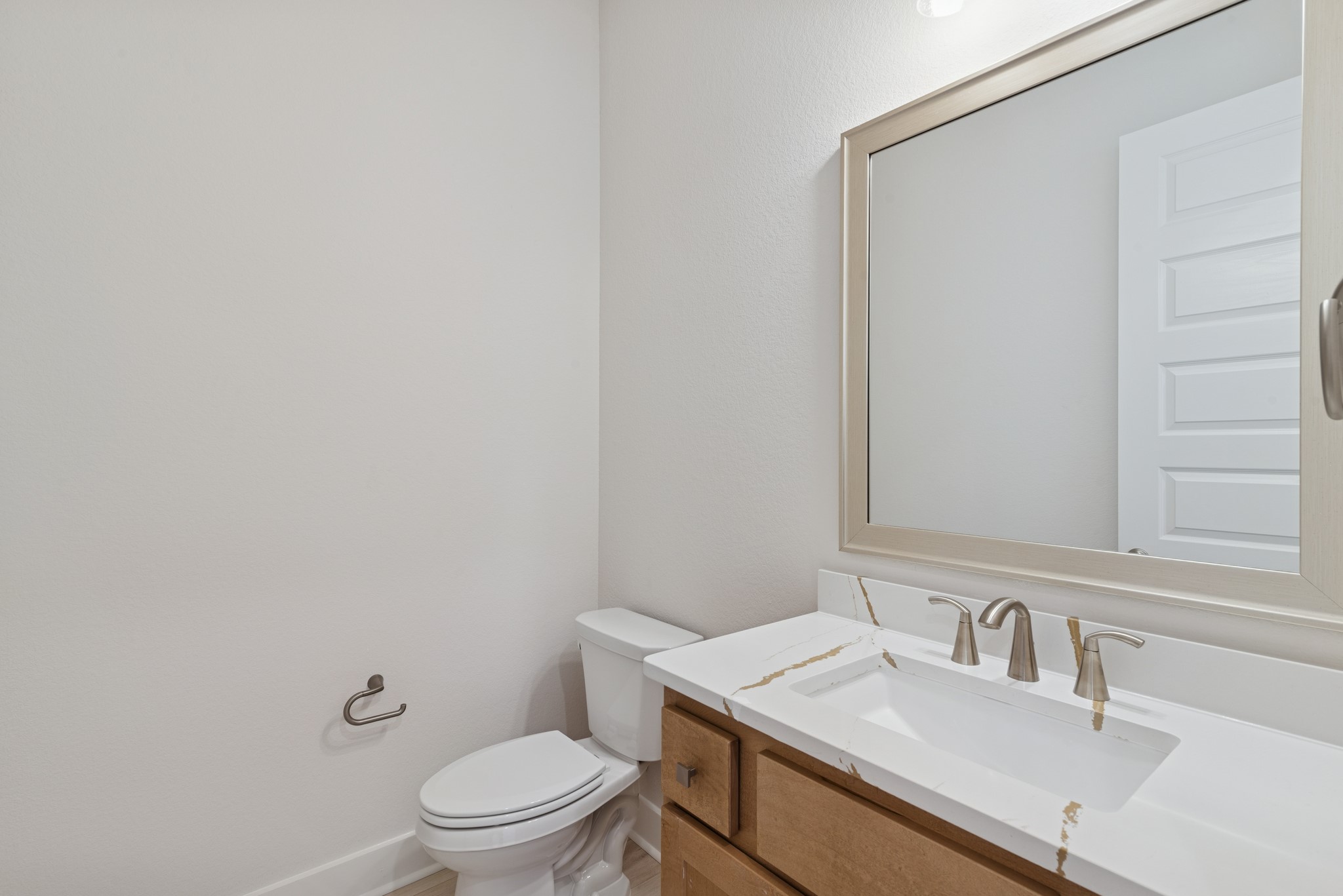 16146 Rita Road Conroe, TX 77302 - Photo 16 of 49 a bathroom with a sink a toilet and a mirror