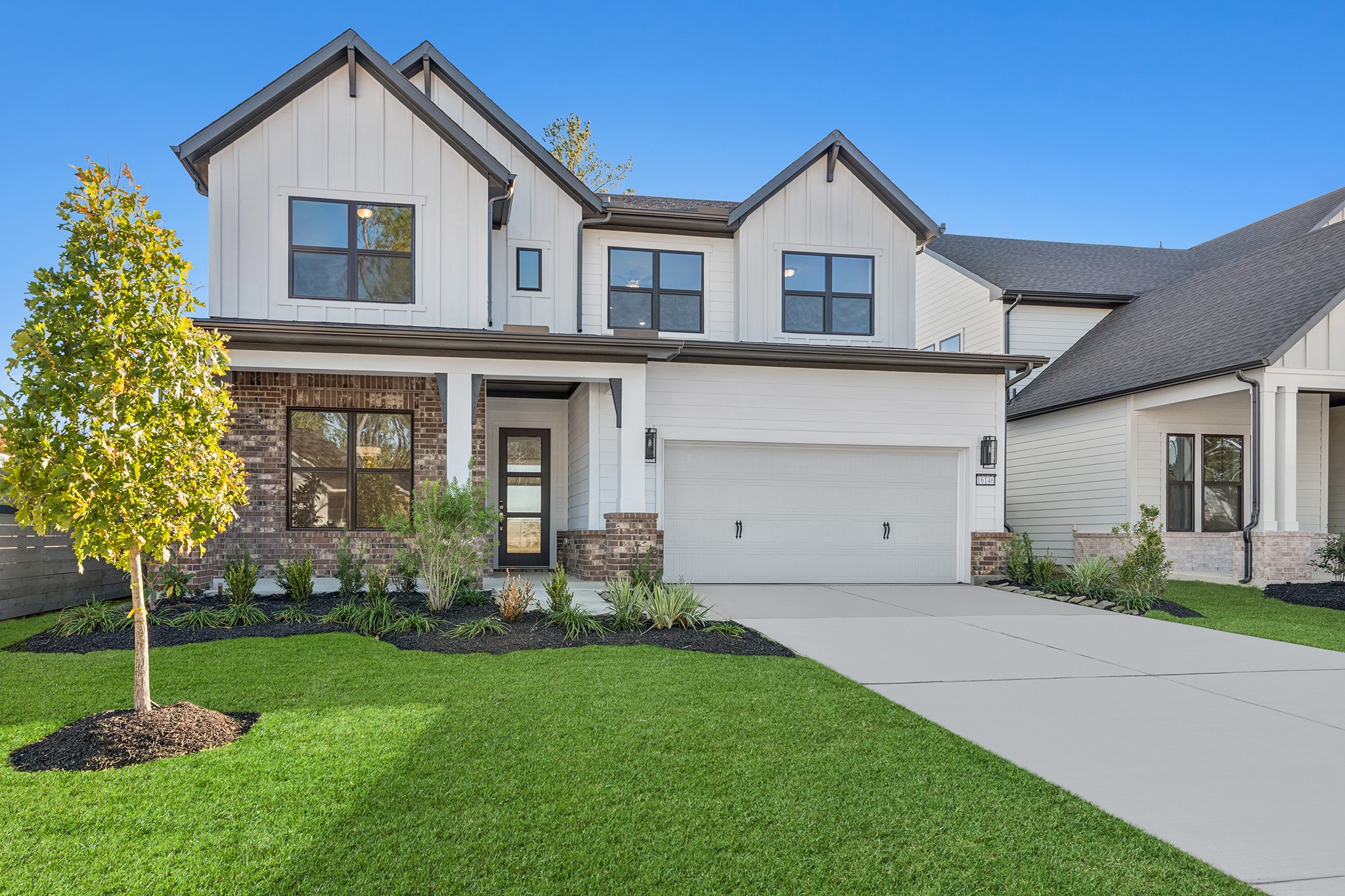 16146 Rita Road Conroe, TX 77302 - Photo 2 of 49 a front view of a house with a garden and trees