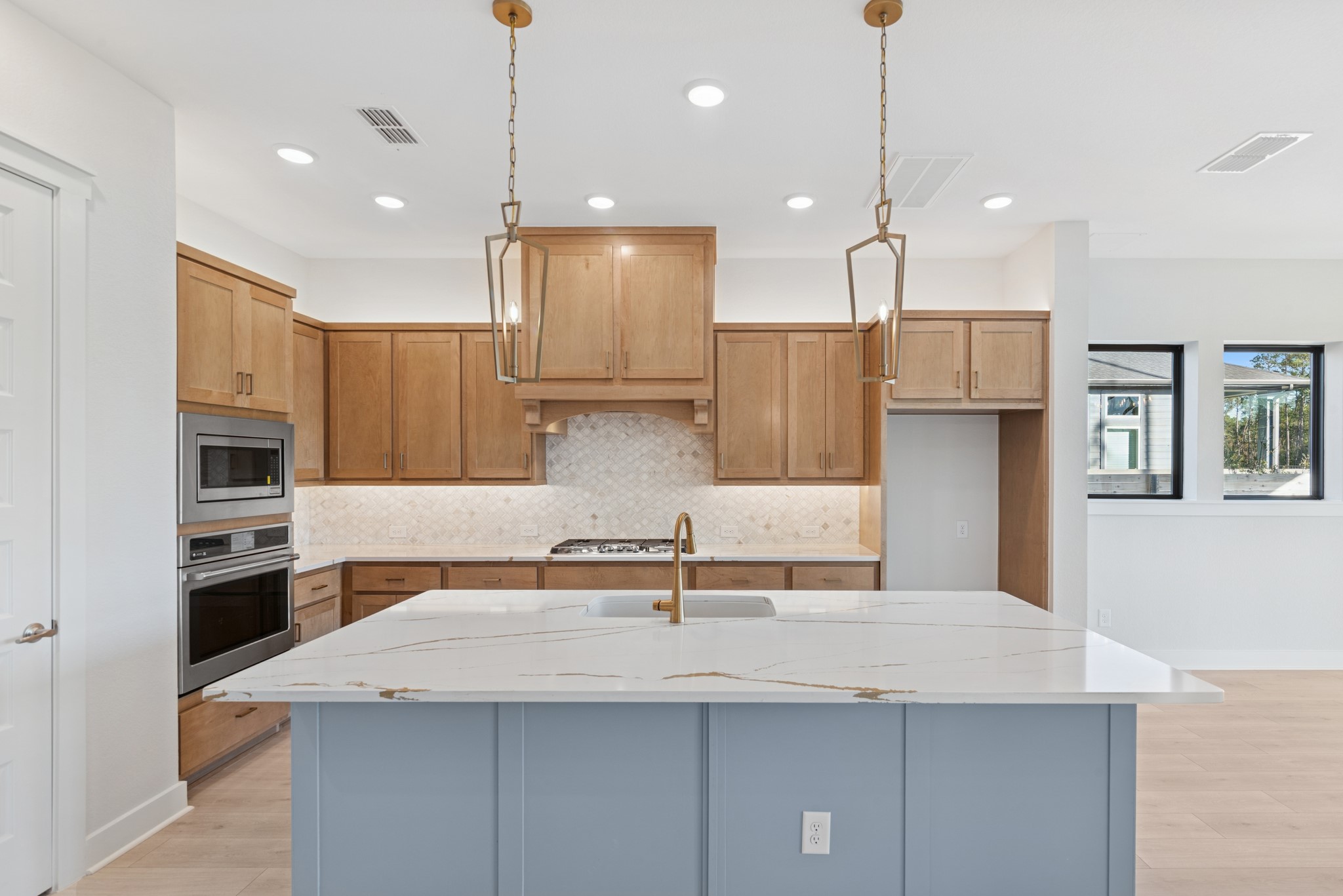 16146 Rita Road Conroe, TX 77302 - Photo 20 of 49 a kitchen with kitchen island a sink stainless steel appliances and cabinets