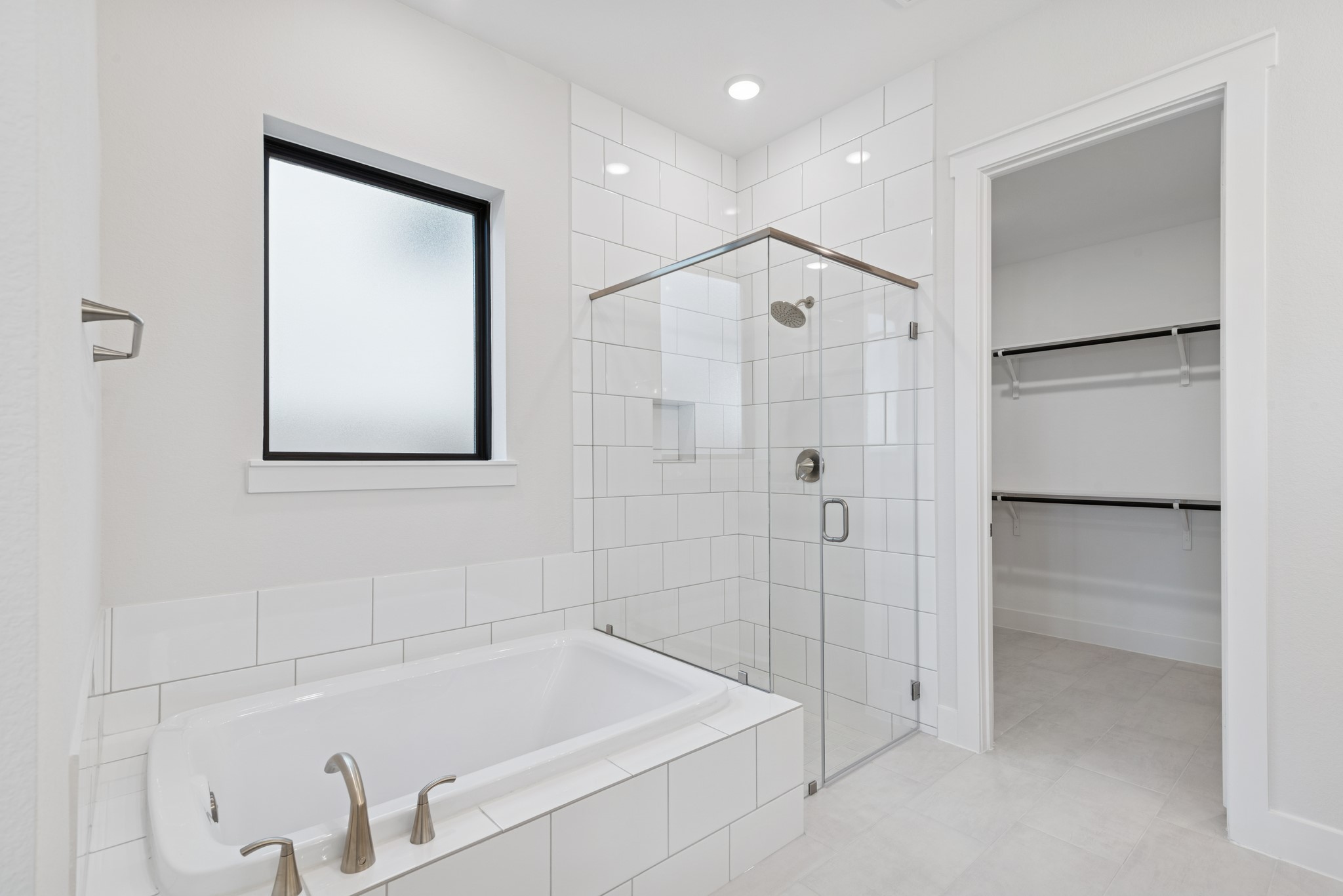 16146 Rita Road Conroe, TX 77302 - Photo 31 of 49 a bathroom with a bathtub and a shower