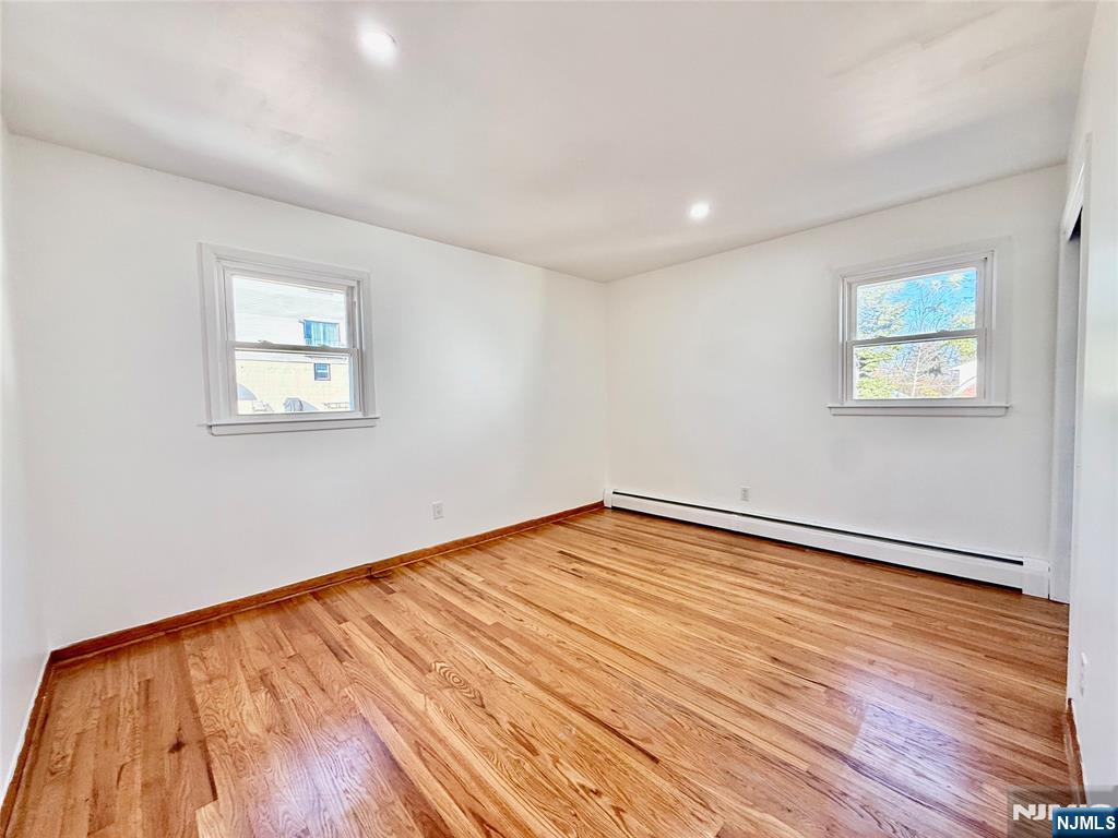 41 Corabelle Avenue, Unit 2 Lodi, NJ 07644 - Photo 18 of 21 a view of empty room with wooden floor and fan