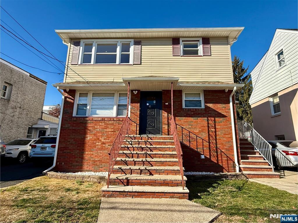 41 Corabelle Avenue, Unit 2 Lodi, NJ 07644 - Photo 2 of 21 a front view of a house with a yard
