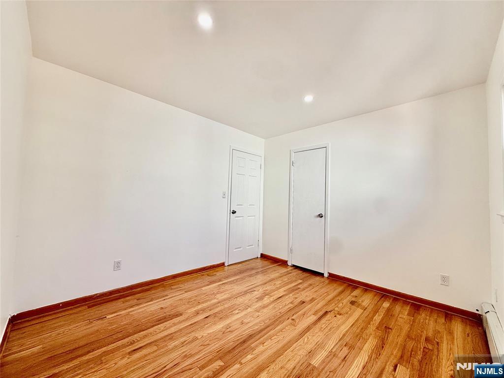 41 Corabelle Avenue, Unit 2 Lodi, NJ 07644 - Photo 21 of 21 a view of an empty room with wooden floor