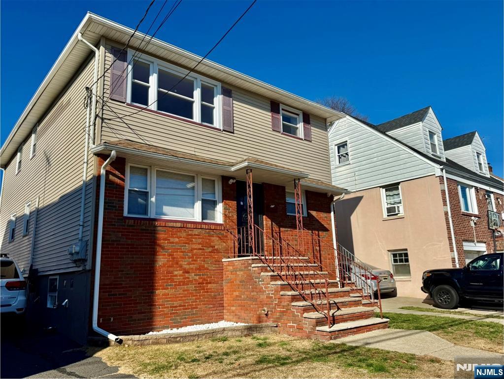 41 Corabelle Avenue, Unit 2 Lodi, NJ 07644 - Photo 3 of 21 a front view of a house with a yard
