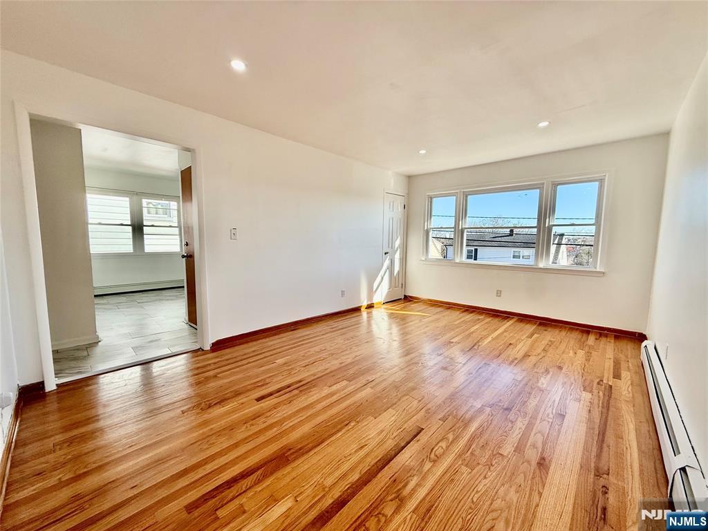 41 Corabelle Avenue, Unit 2 Lodi, NJ 07644 - Photo 7 of 21 a view of empty room with wooden floor and fan