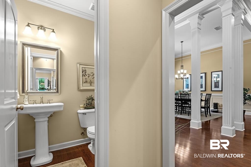 29976 Dolive Ridge Daphne, AL 36527 - Photo 27 of 58 Bathroom featuring wood-type flooring, toilet, decorative columns, and ornamental molding