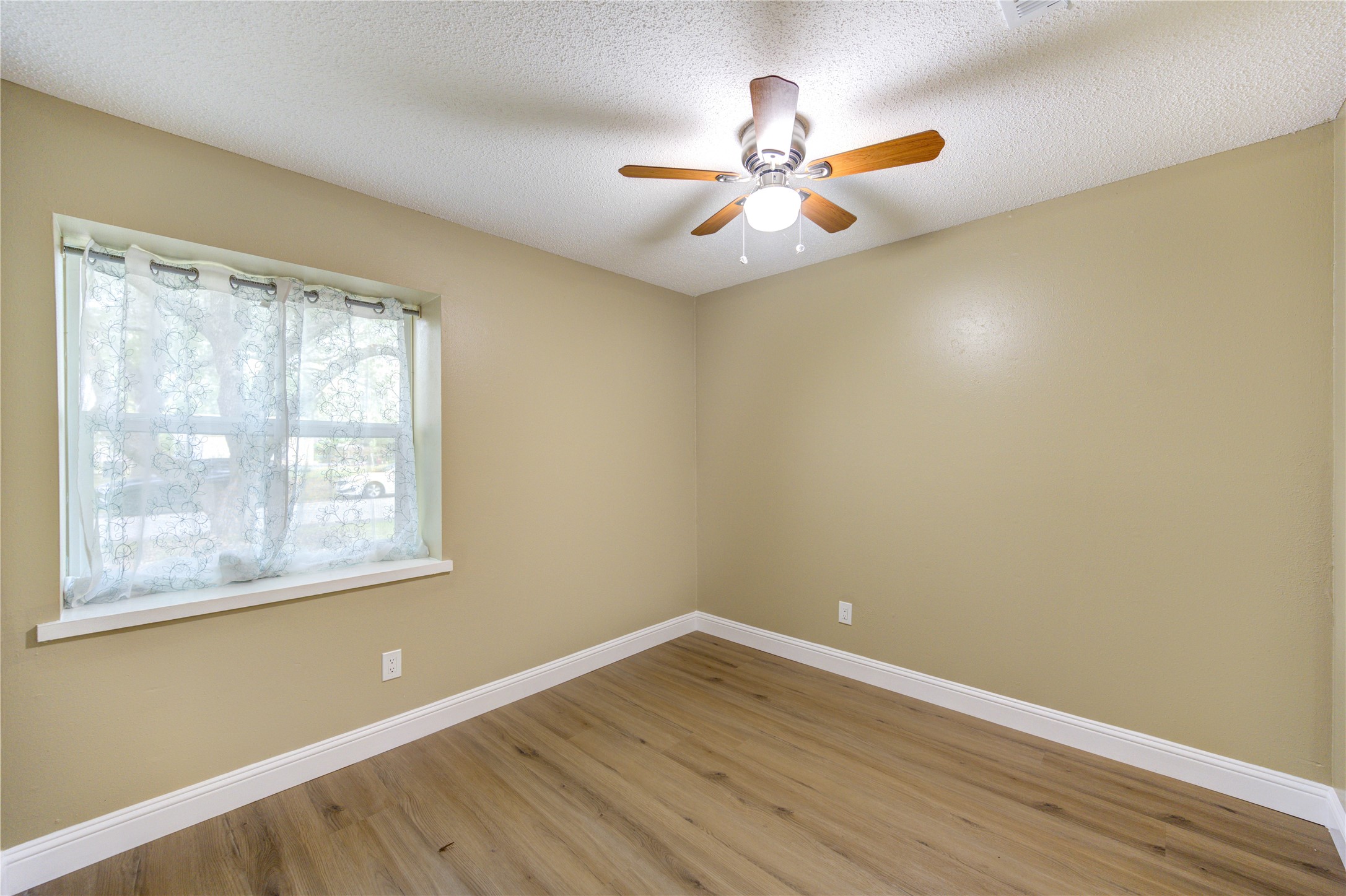 1921 Ripple Creek Drive Rosenberg, TX 77471 - Photo 15 of 17 a view of an empty room with wooden floor and a window