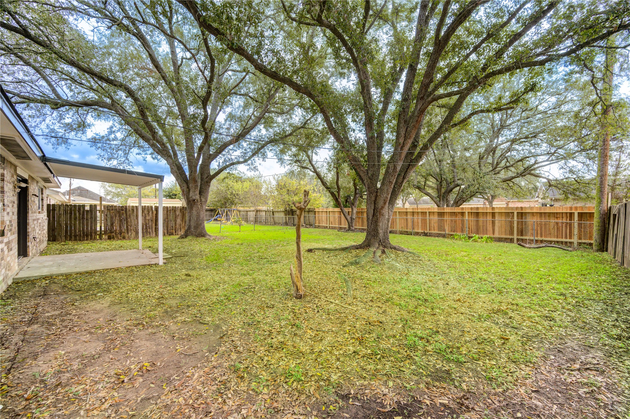 1921 Ripple Creek Drive Rosenberg, TX 77471 - Photo 17 of 17 a view of a yard with a house and large trees