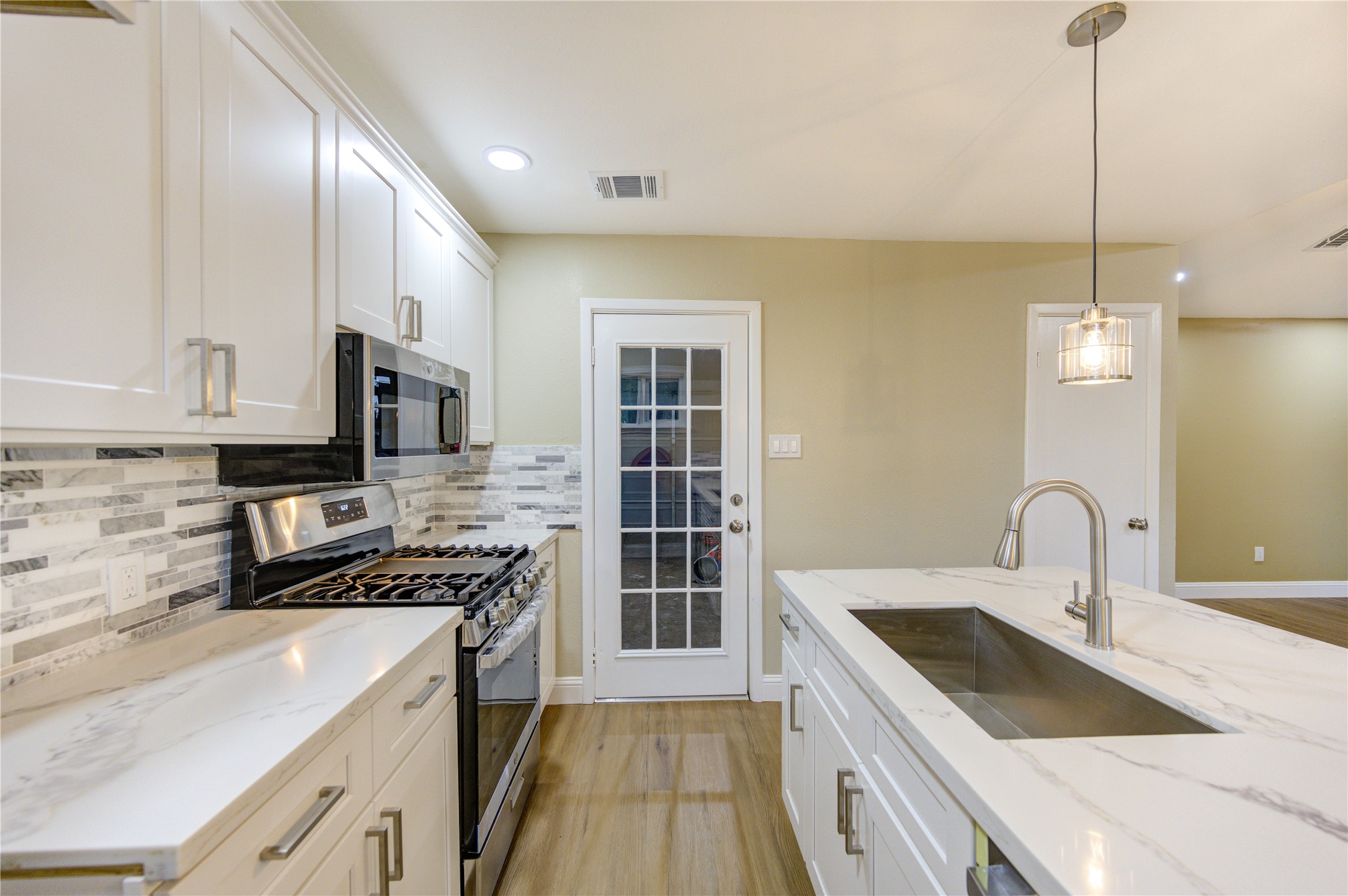 1921 Ripple Creek Drive Rosenberg, TX 77471 - Photo 4 of 17 a kitchen with a sink stove and cabinets