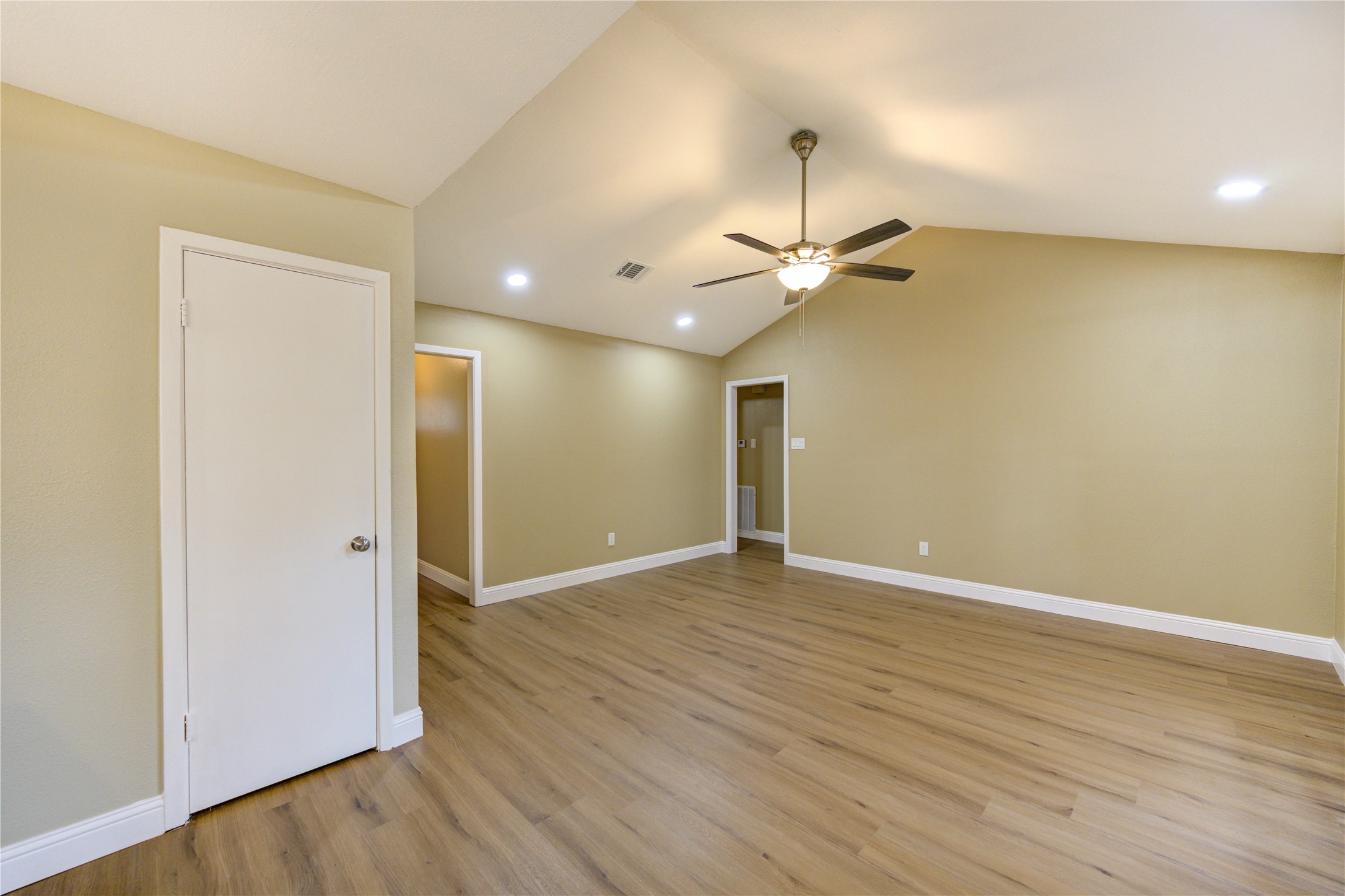 1921 Ripple Creek Drive Rosenberg, TX 77471 - Photo 8 of 17 an empty room with wooden floor and a ceiling fan