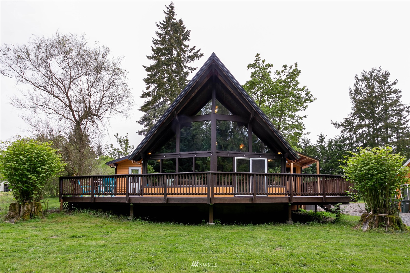 15722 240th Street East Graham, WA 98338 - Photo 1 of 40 a view of a house with a backyard and a wooden deck
