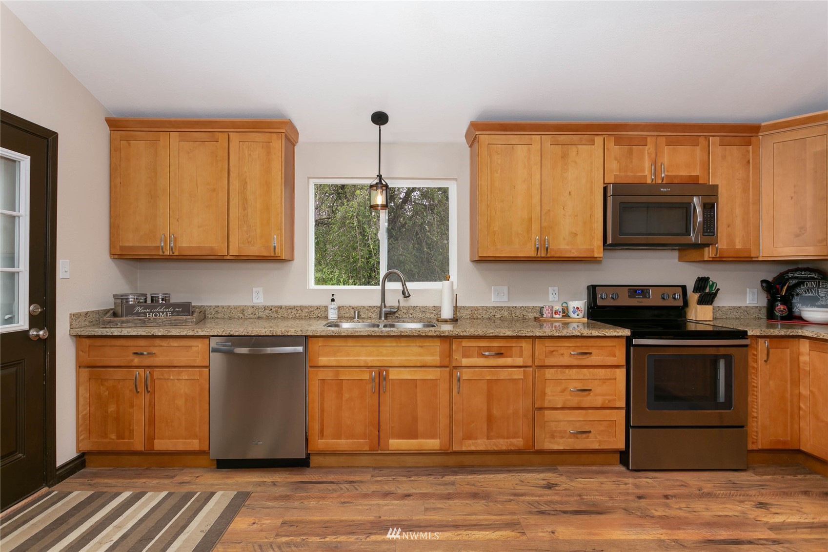 15722 240th Street East Graham, WA 98338 - Photo 14 of 40 a kitchen with stainless steel appliances granite countertop a sink stove and microwave