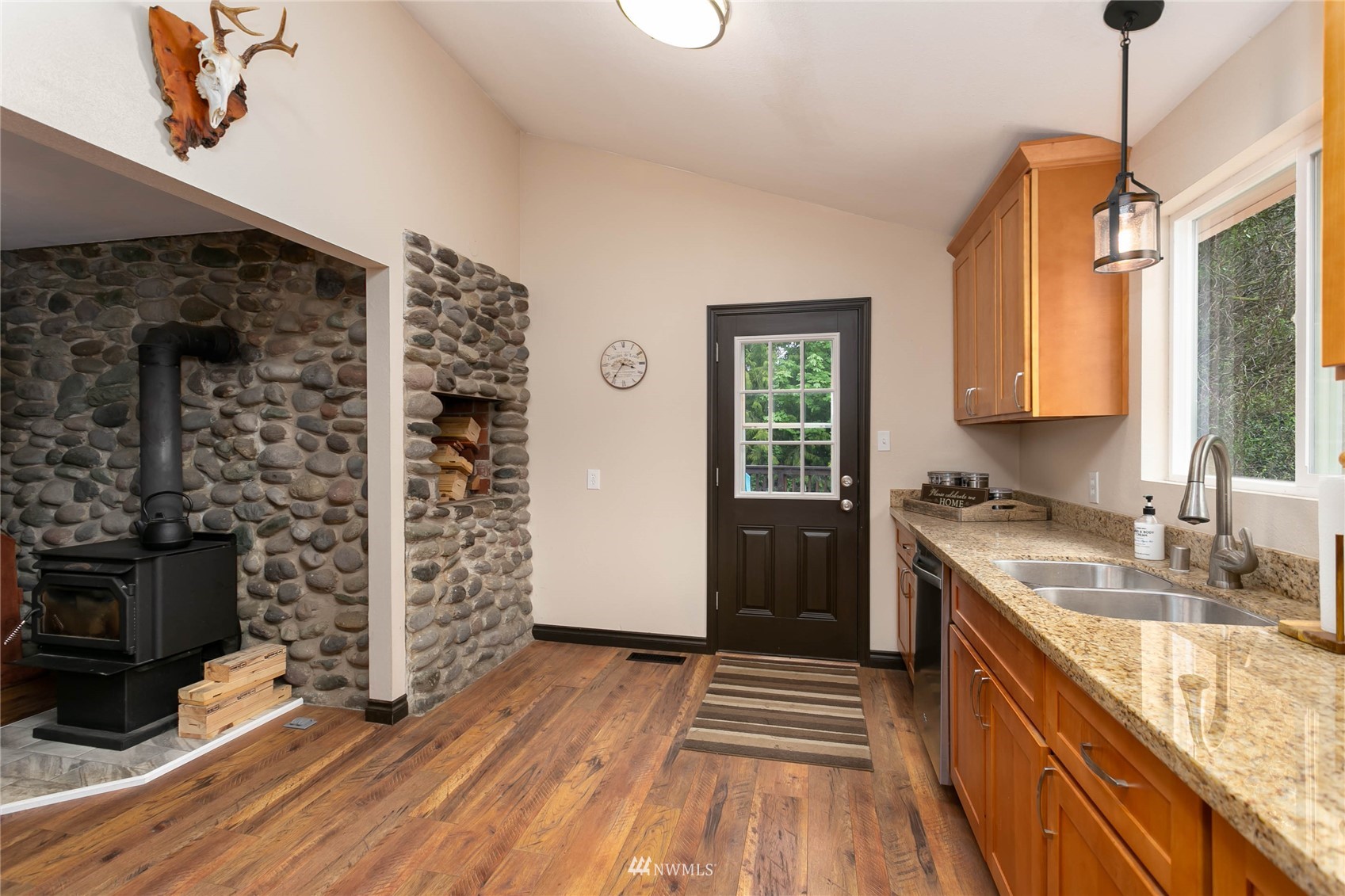 15722 240th Street East Graham, WA 98338 - Photo 16 of 40 a kitchen with stainless steel appliances granite countertop a sink stove and refrigerator