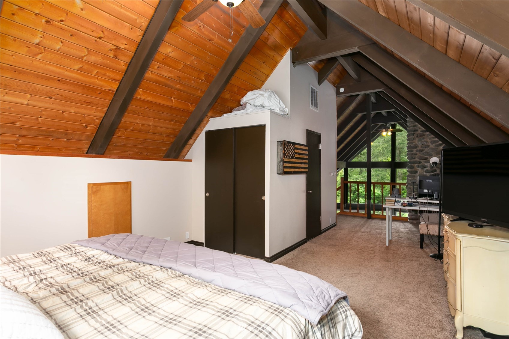 15722 240th Street East Graham, WA 98338 - Photo 18 of 40 a bedroom with a bed and a tv