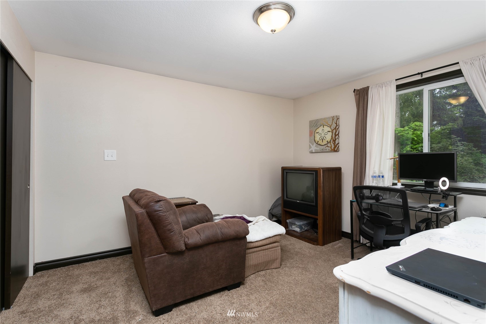 15722 240th Street East Graham, WA 98338 - Photo 21 of 40 a living room with furniture a flat screen tv and a fireplace