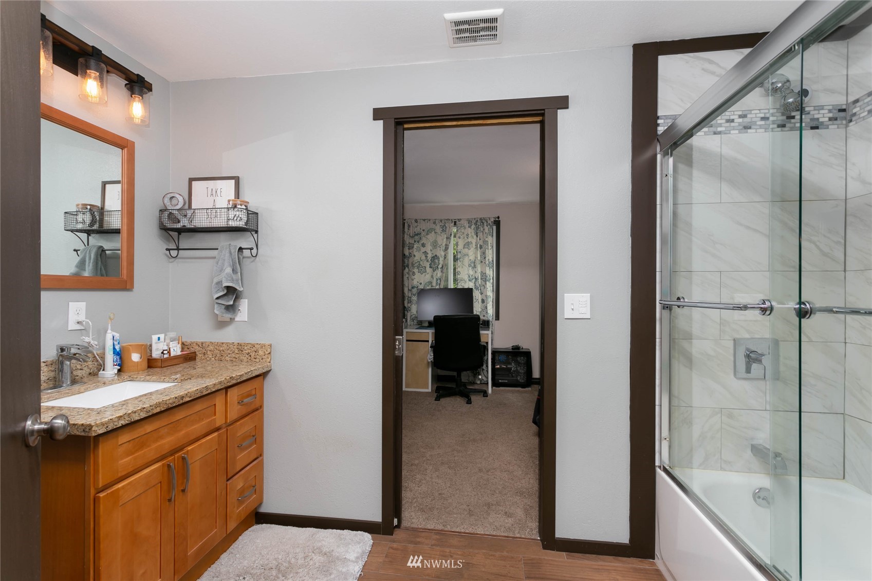 15722 240th Street East Graham, WA 98338 - Photo 22 of 40 a bathroom with a granite countertop sink mirror and a bathtub