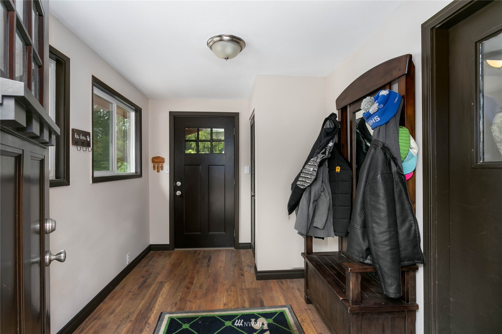 15722 240th Street East Graham, WA 98338 - Photo 6 of 40 a view of a hallway with wooden floor and stairs