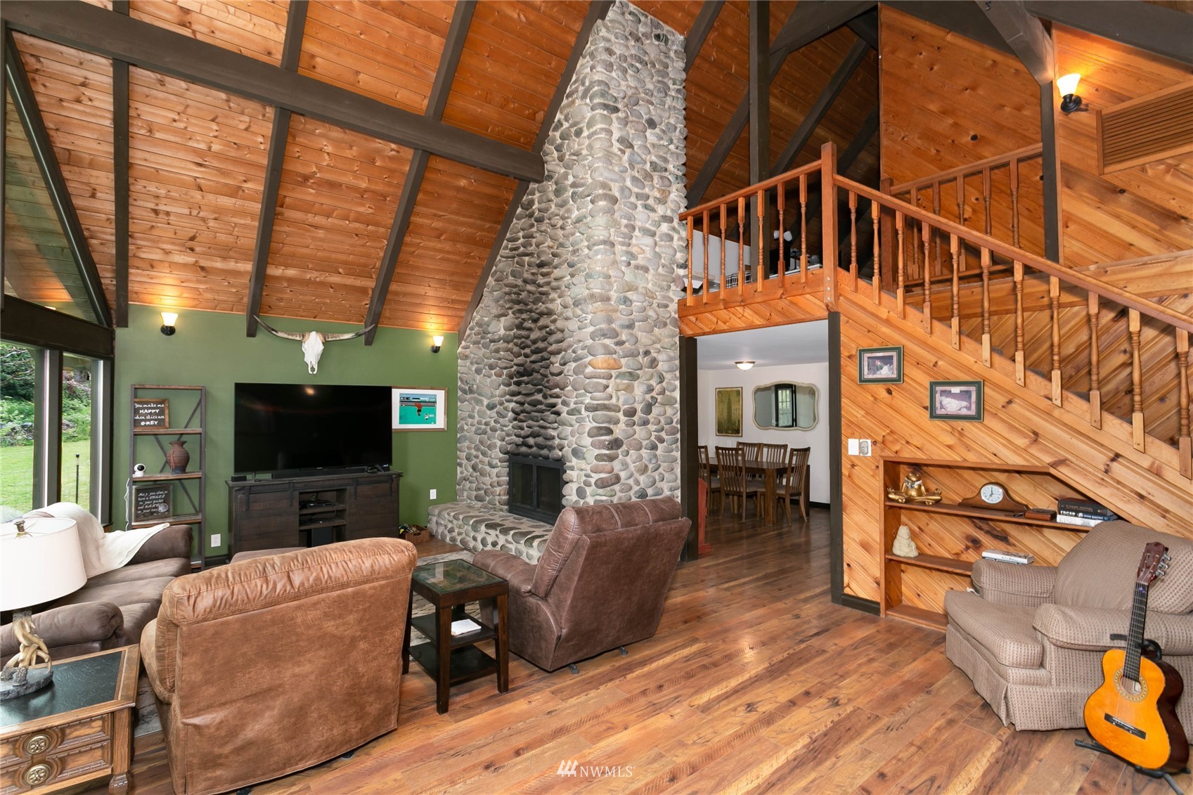15722 240th Street East Graham, WA 98338 - Photo 8 of 40 a living room with furniture a flat screen tv and a fireplace