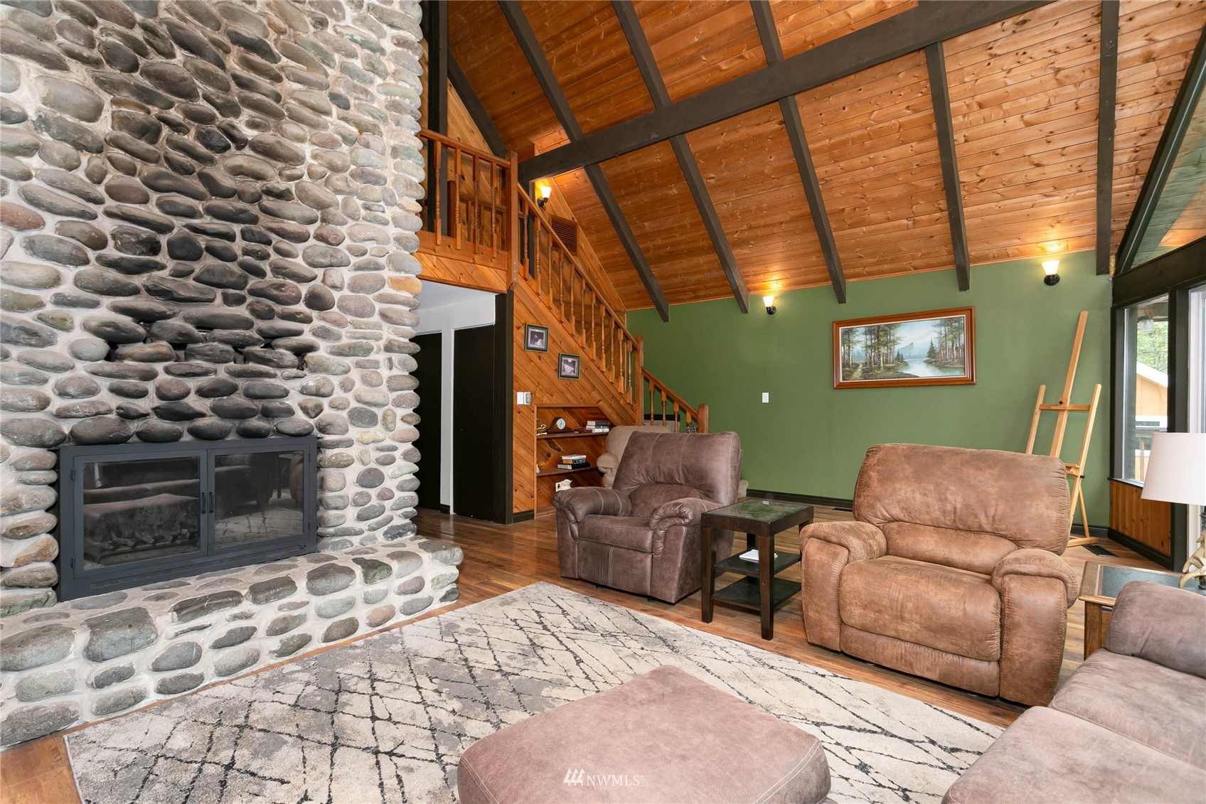 15722 240th Street East Graham, WA 98338 - Photo 10 of 40 a living room with furniture a flat screen tv and a fireplace