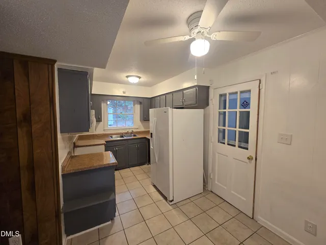 a kitchen with stainless steel appliances a refrigerator and a cabinets