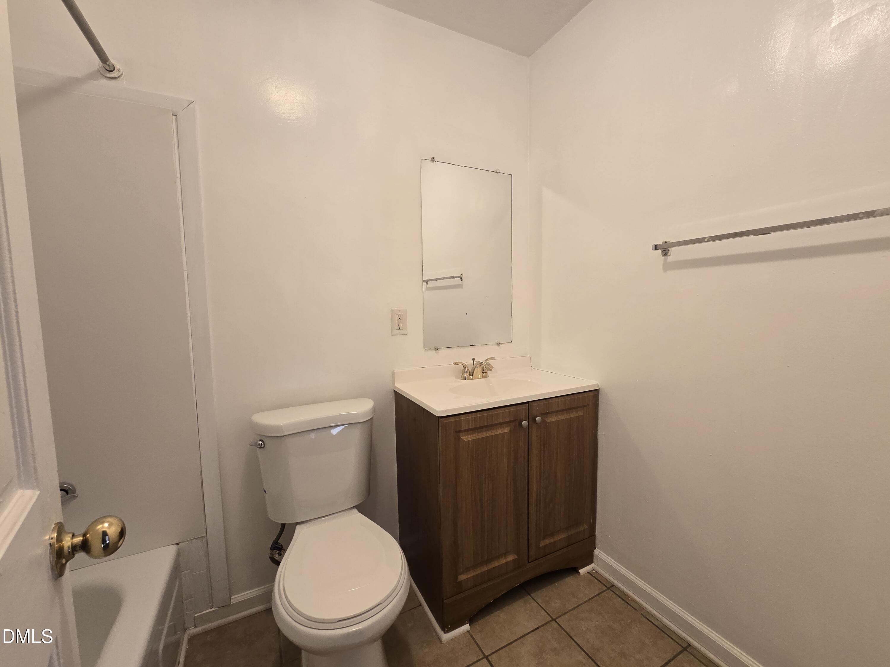 4311 Pope Road Durham, NC 27707 - Photo 13 of 23 a bathroom with a toilet a sink and mirror