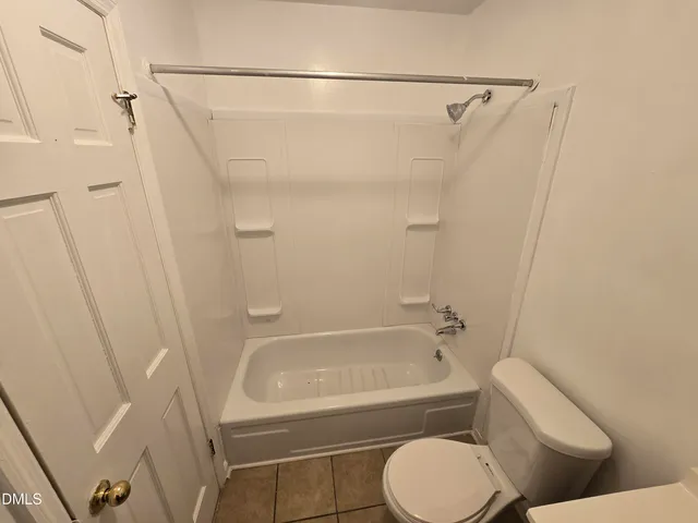 a bathroom with a toilet and a bathtub