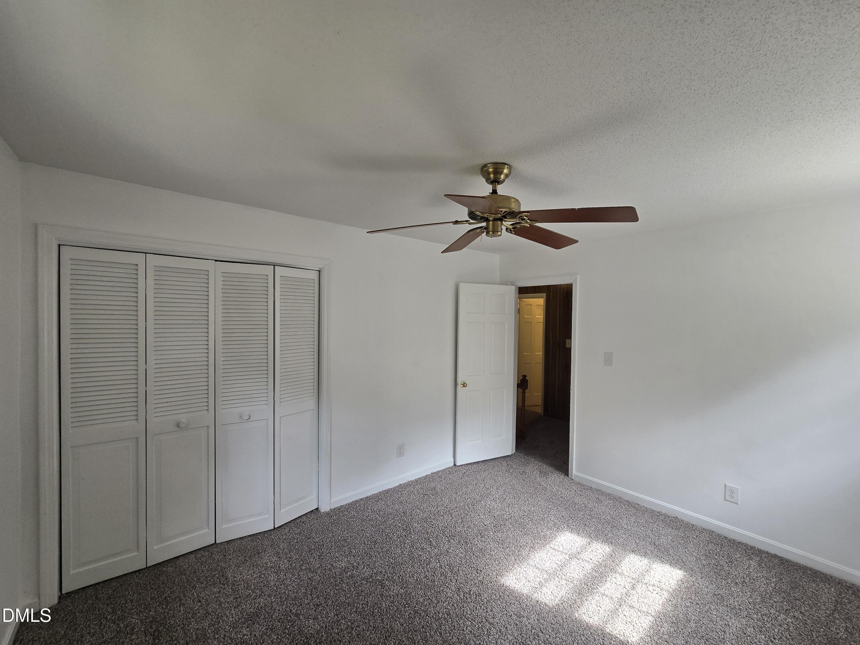 4311 Pope Road Durham, NC 27707 - Photo 17 of 23 a view of a livingroom with a chandelier fan and closet