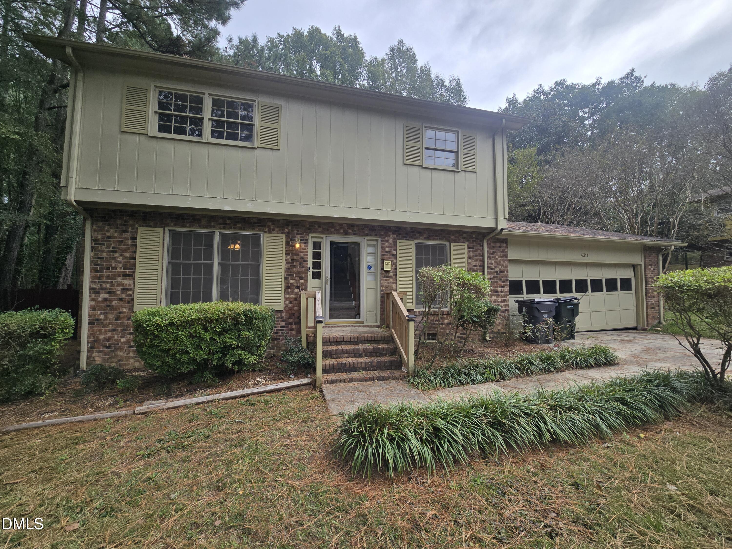 4311 Pope Road Durham, NC 27707 - Photo 2 of 23 a front view of a house with a garden