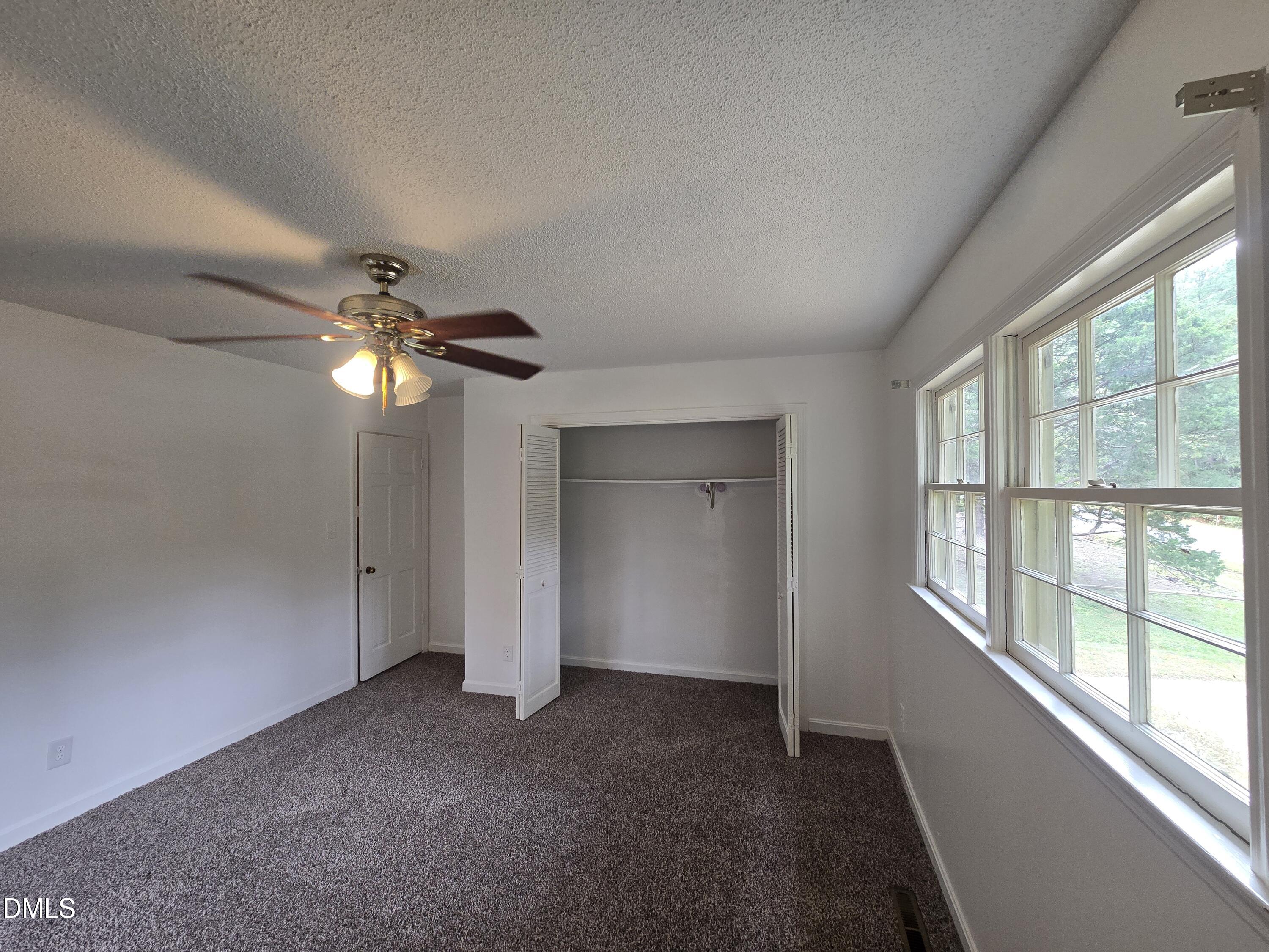 4311 Pope Road Durham, NC 27707 - Photo 22 of 23 en empty room with windows and ceiling fan