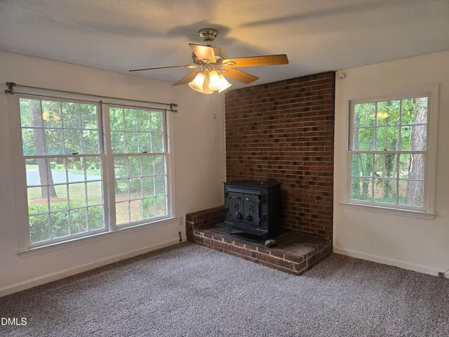 a living room with a fireplace and a flat screen tv