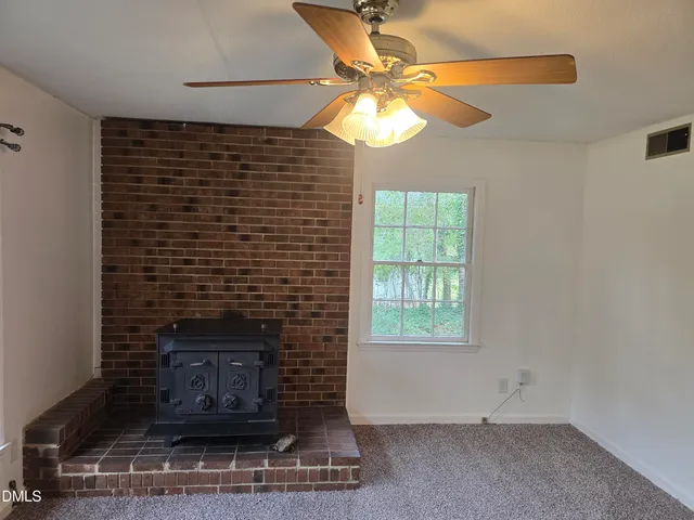 a room with a fireplace and a chandelier