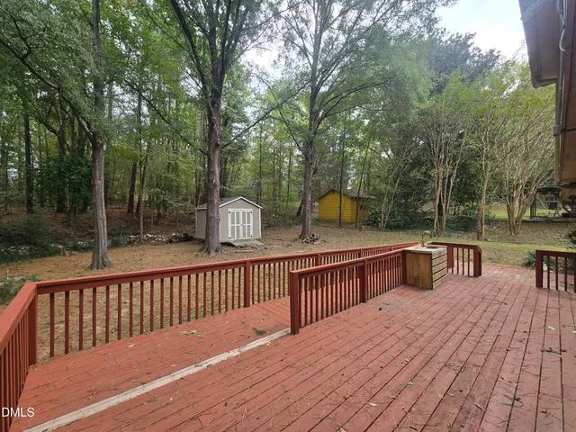 a view of a deck with chairs next to a yard