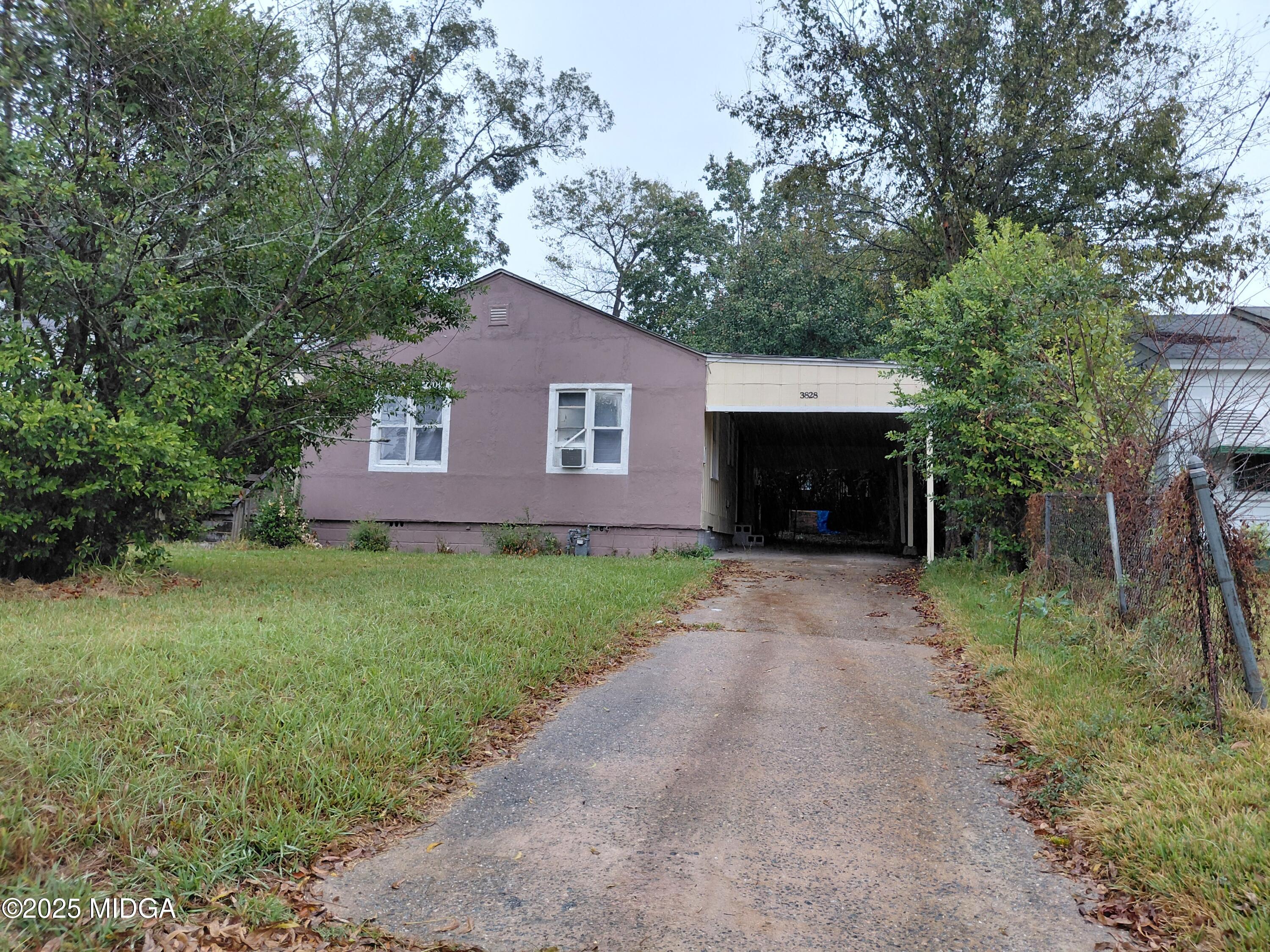 a front view of a house with a garden and yard