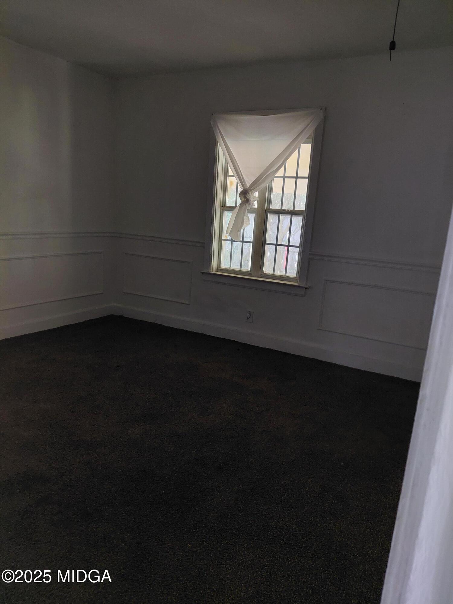 3828 Lyons Street Macon, GA 31206 - Photo 7 of 8 a view of an empty room with a window