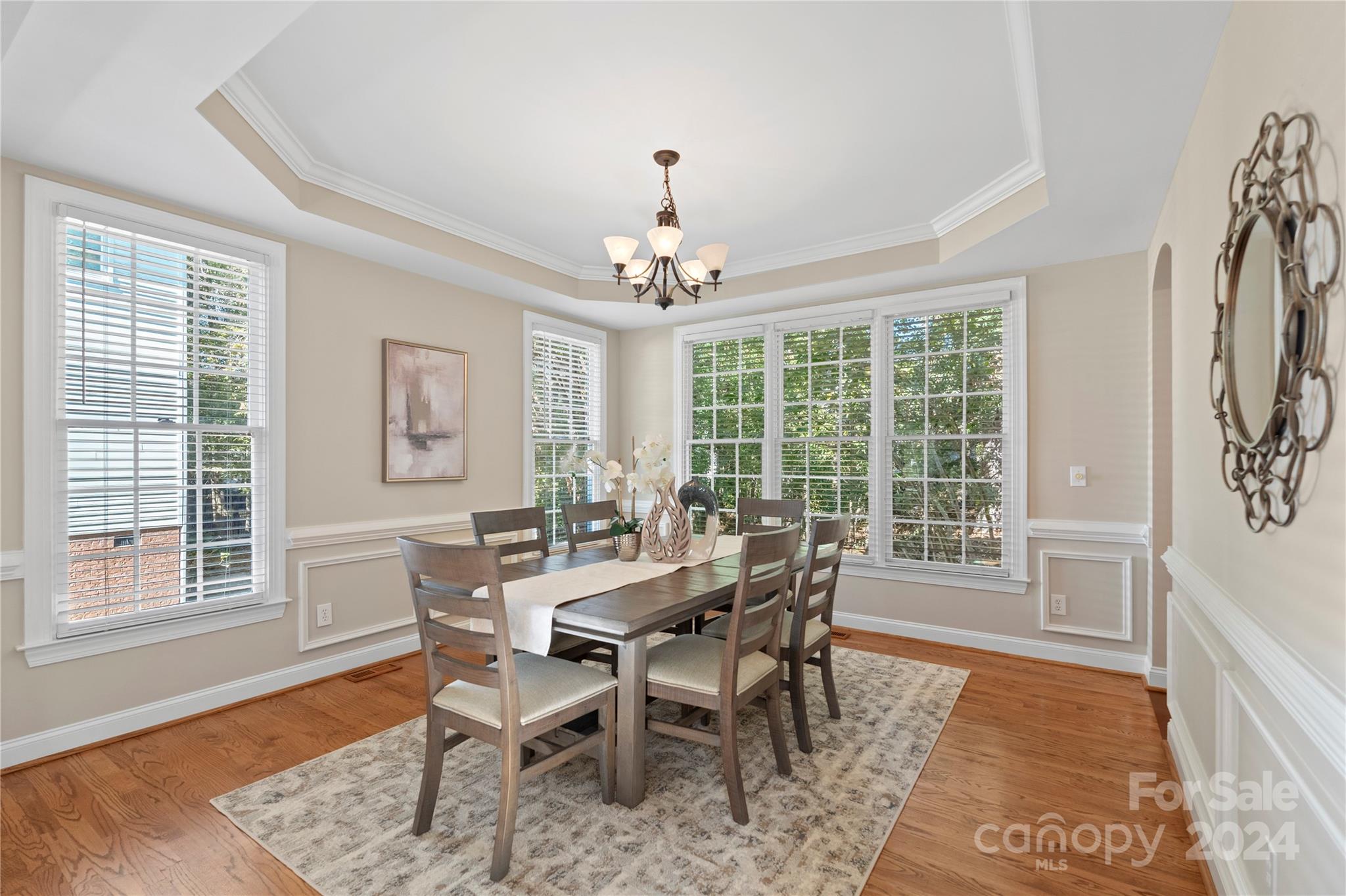 3417 Rhett Butler Place Charlotte, NC 28270 - Photo 12 of 48 a dining room with furniture a chandelier and wooden floor