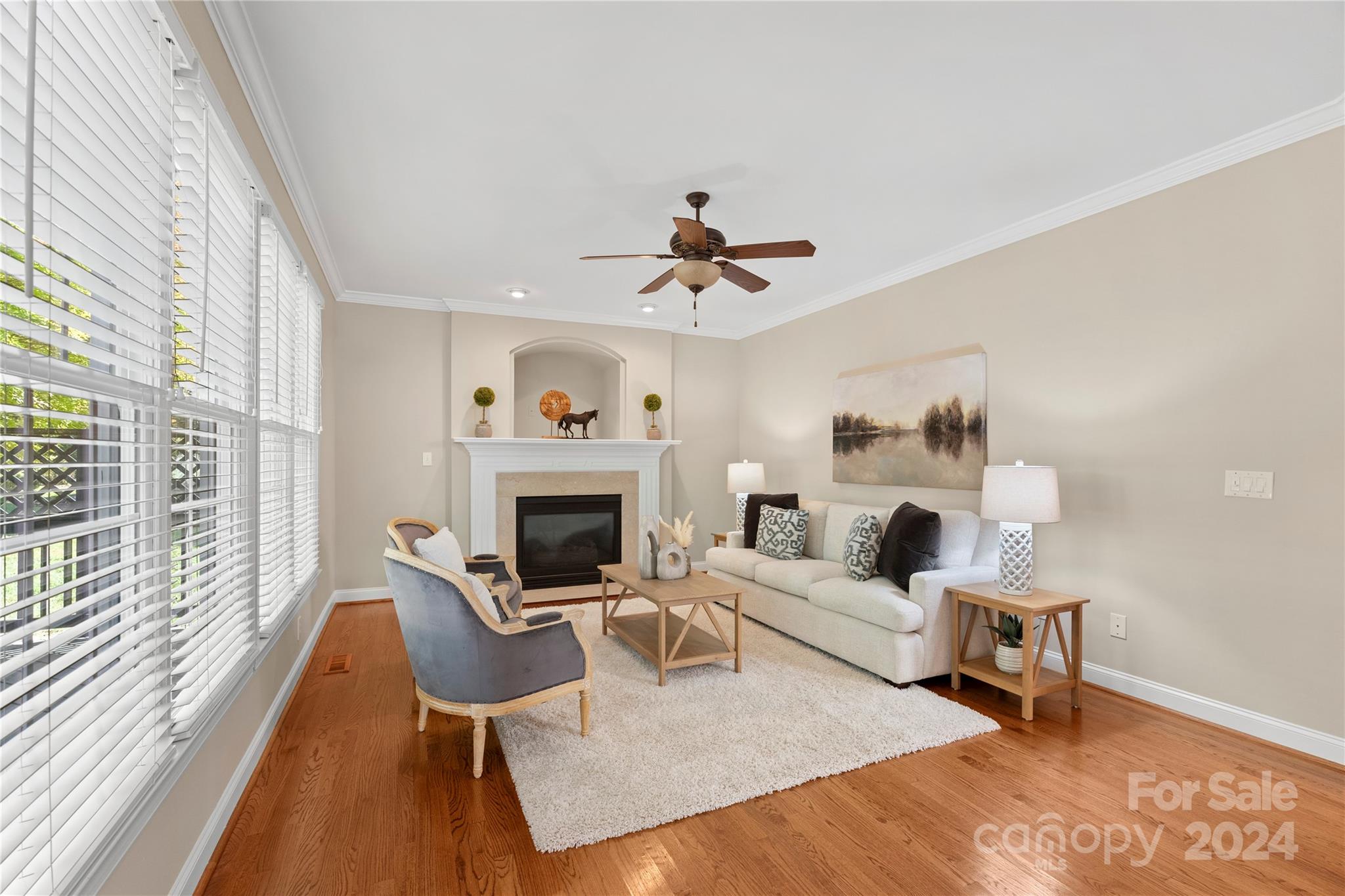 3417 Rhett Butler Place Charlotte, NC 28270 - Photo 16 of 48 a living room with furniture a fireplace and a floor to ceiling window
