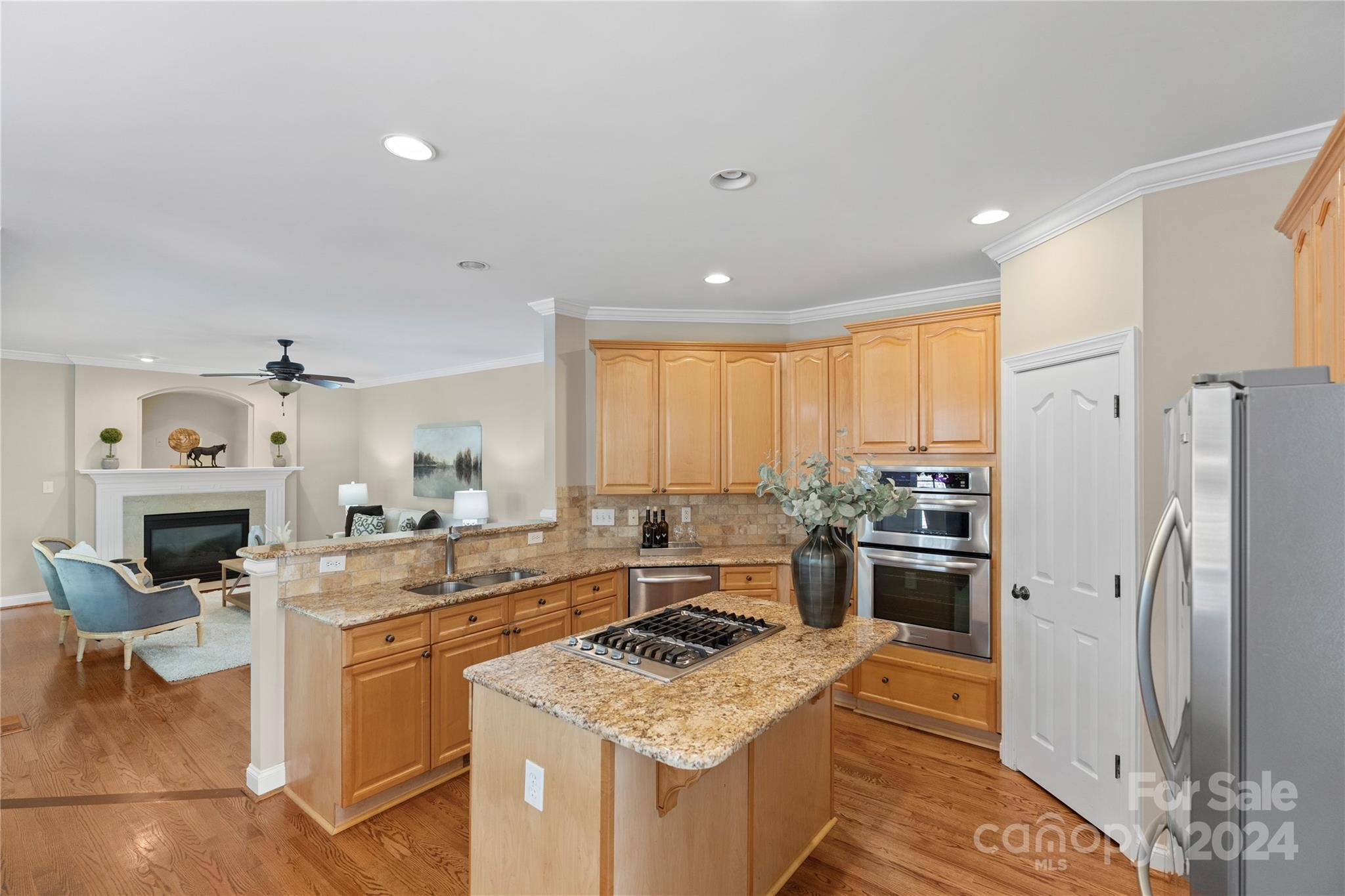 3417 Rhett Butler Place Charlotte, NC 28270 - Photo 20 of 48 a kitchen with stainless steel appliances kitchen island granite countertop a refrigerator stove oven and sink