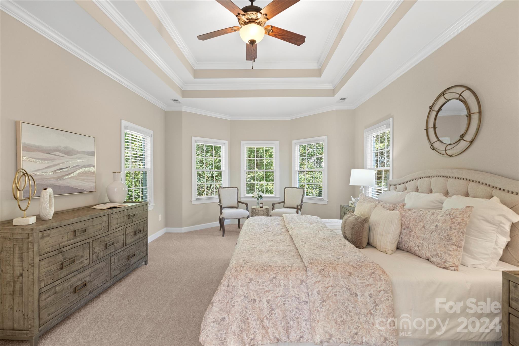 3417 Rhett Butler Place Charlotte, NC 28270 - Photo 28 of 48 a spacious bedroom with a large bed and a chandelier