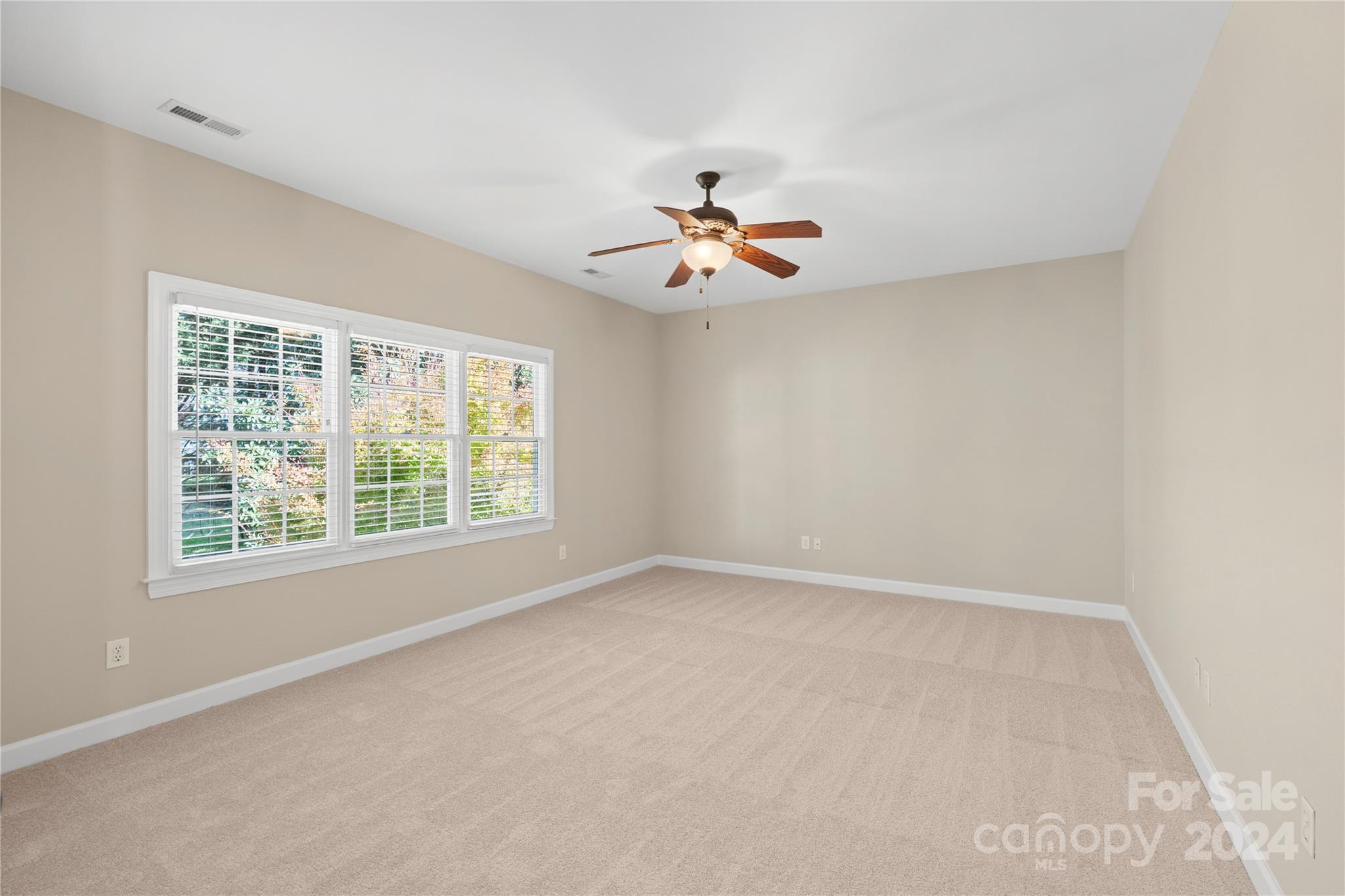 3417 Rhett Butler Place Charlotte, NC 28270 - Photo 36 of 48 an empty room with windows and a ceiling fan
