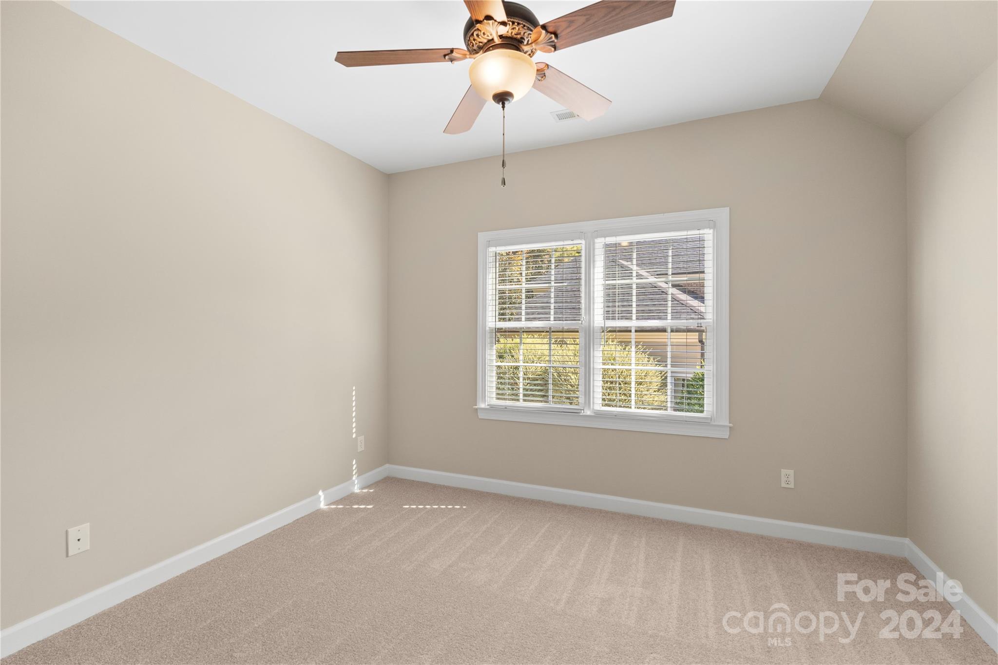 3417 Rhett Butler Place Charlotte, NC 28270 - Photo 38 of 48 an empty room with a window and a fan