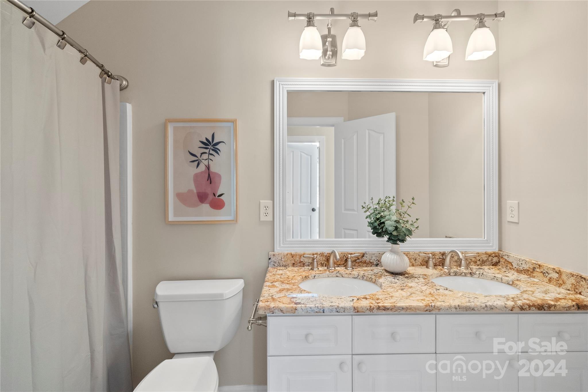 3417 Rhett Butler Place Charlotte, NC 28270 - Photo 40 of 48 a bathroom with a granite countertop toilet sink and mirror