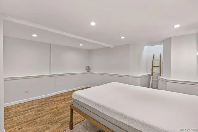 a bedroom with a bed and a night stand